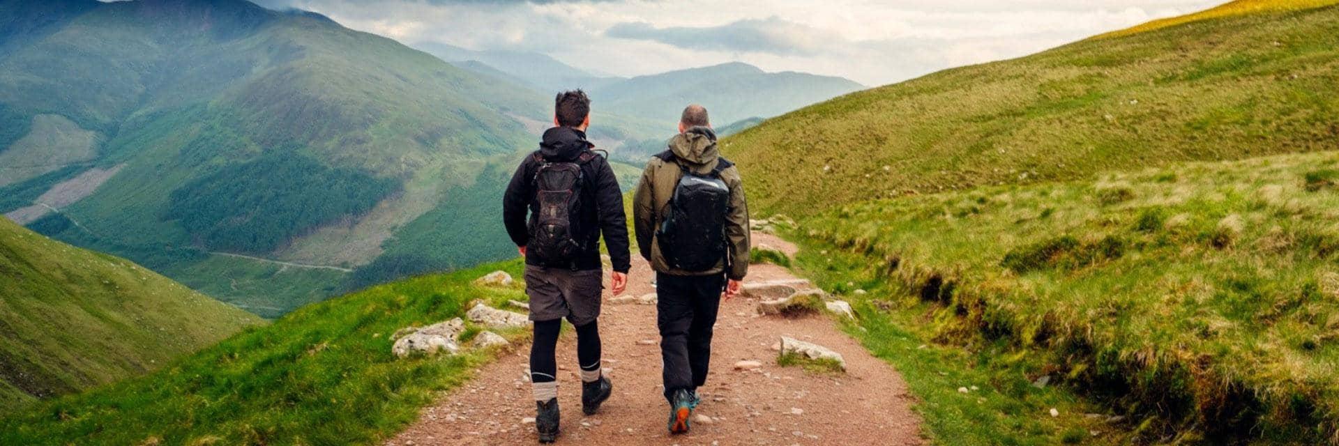 Two men hiking on hilly terrain. Resilience to COVID-19 means businesses are ready for the future.
